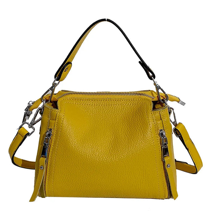Gelbe Lederhandtasche mit Reißverschlüssen, verstellbarem Schulterriemen, modisch, Damenaccessoire.