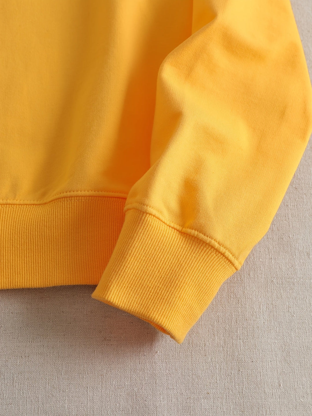 Gelber Baumwollpullover Ärmel Detailansicht, modisch, bequem, hochwertig, Freizeitkleidung.