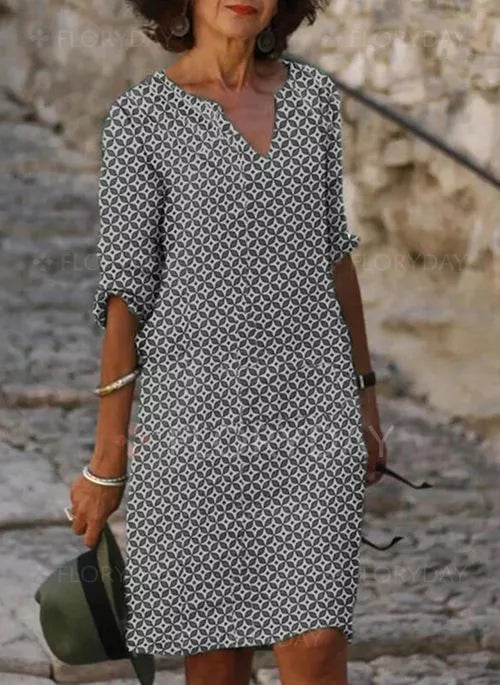 Elegantes Damen-Sommerkleid, schwarz-weiß gemustert, knielang, V-Ausschnitt, Freizeitmode.
