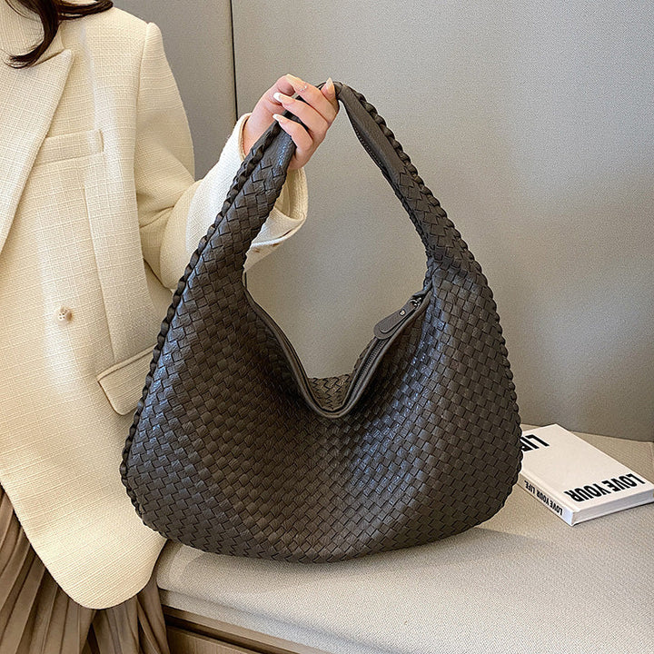 Dunkelgraue geflochtene Handtasche aus Leder, modisch, elegant, Damenaccessoire.