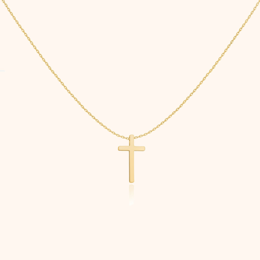 Goldene Kreuzkette, minimalistisches Design, eleganter Schmuck, religiöses Accessoire, Damenmode.