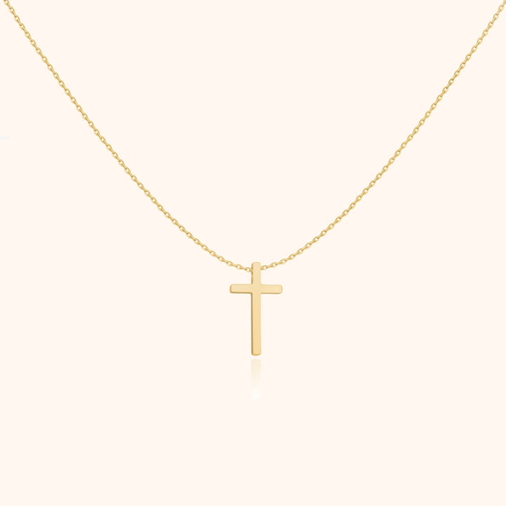 Goldene Kreuzkette, minimalistisches Design, eleganter Schmuck, religiöses Accessoire, Damenmode.
