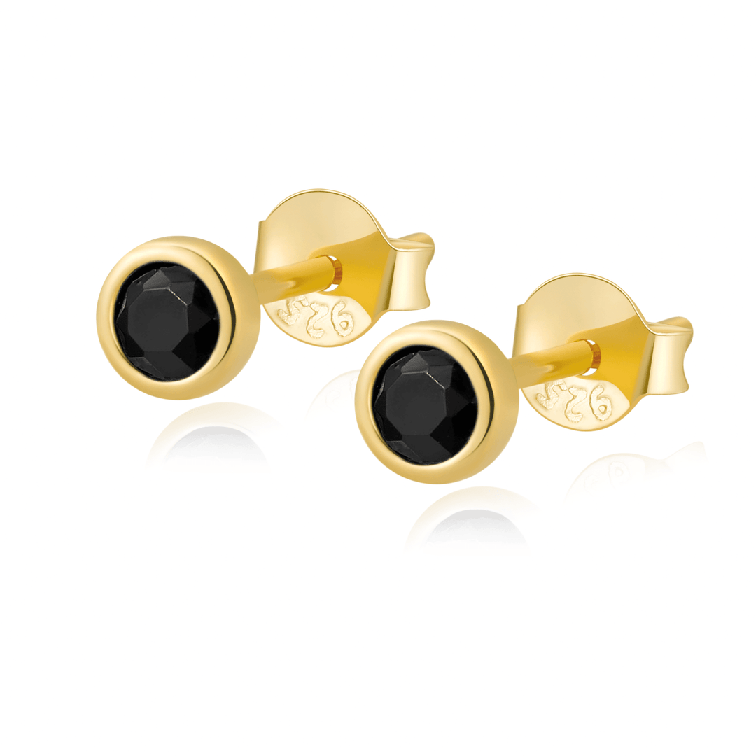 Goldene Ohrringe mit schwarzem Stein, eleganter Schmuck, Damenaccessoire, stilvoll und modern.