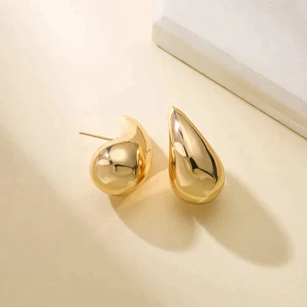 Goldene Tropfen-Ohrringe, glänzend, modisch, Schmuck für Damen, elegantes Design.