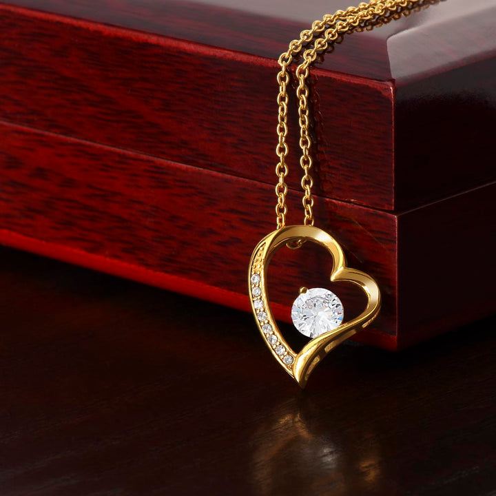 Goldene Herz-Halskette mit Diamantanhänger auf Holzschatulle, eleganter Schmuck, Geschenkidee.