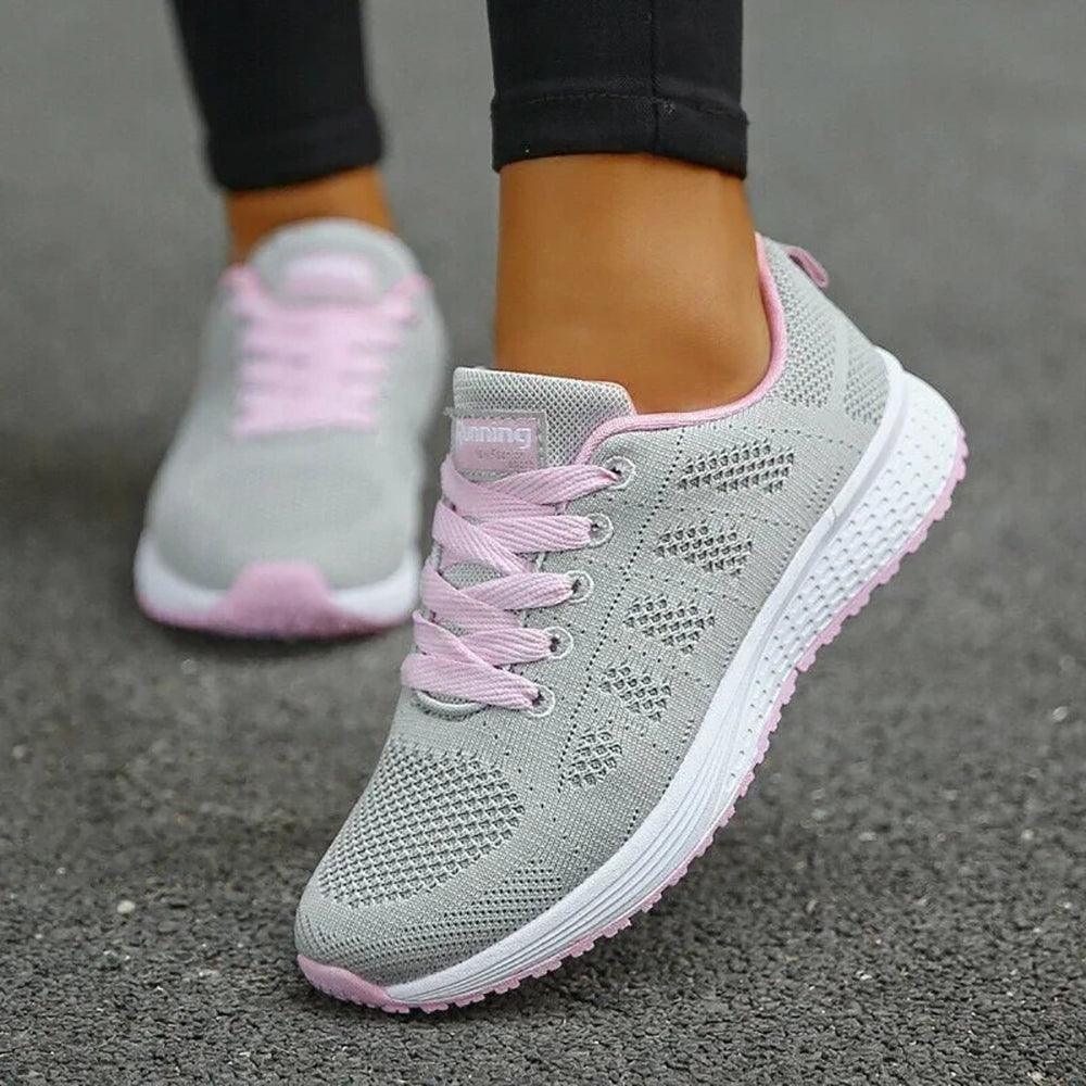 Graue Damen-Laufschuhe mit rosa Schnürsenkeln, atmungsaktives Mesh, sportlich, bequem.