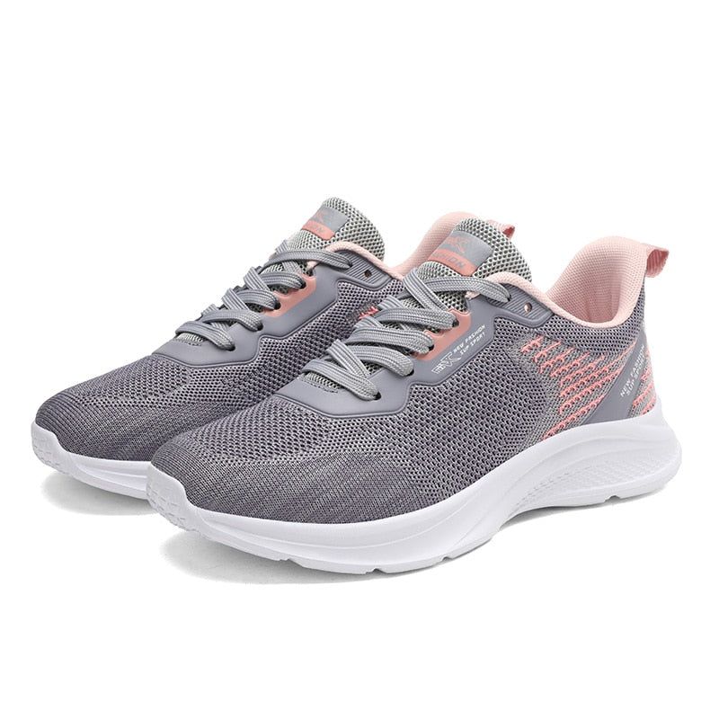 Graue Damen-Laufschuhe, atmungsaktiv, mit rosa Akzenten, ideal für Sport und Freizeit.