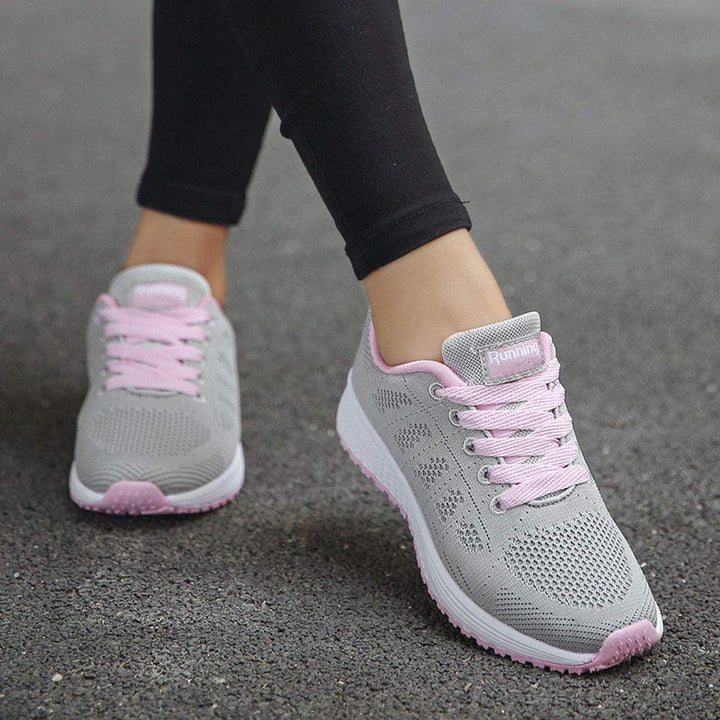 Graue Damen-Laufschuhe mit rosa Schnürsenkeln, atmungsaktiv, ideal für Sport und Freizeit.