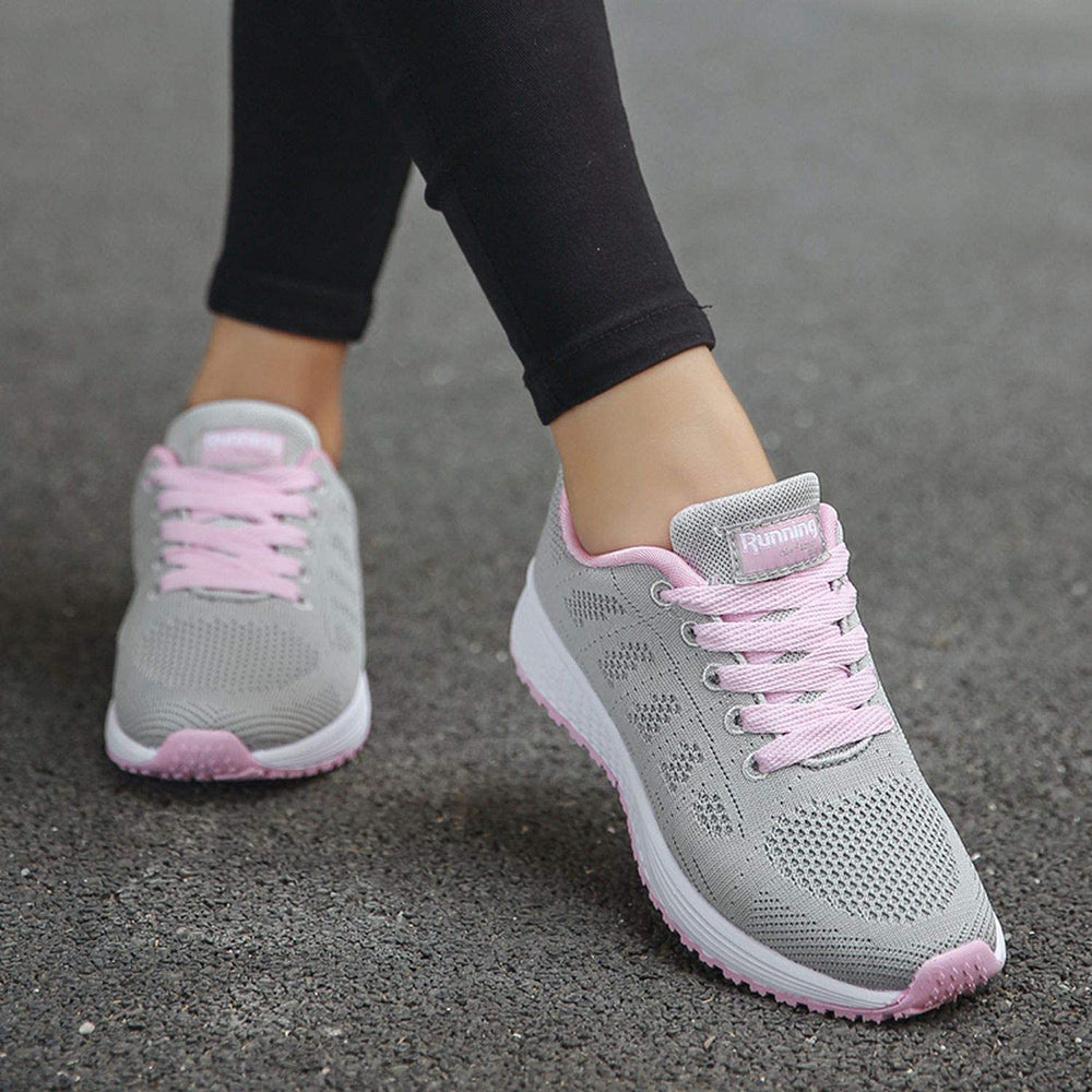 Graue Damen-Laufschuhe mit rosa Schnürsenkeln, atmungsaktiv, ideal für Sport und Freizeit.