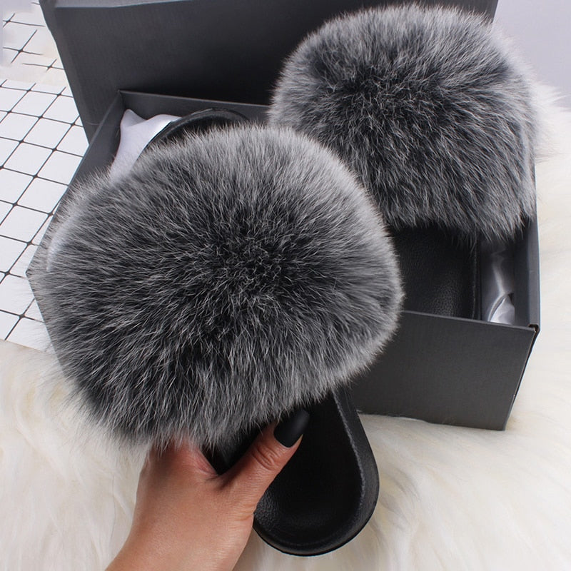 Graue flauschige Pelzhausschuhe in schwarzer Box, Damenmode, gemütliche Pantoffeln.