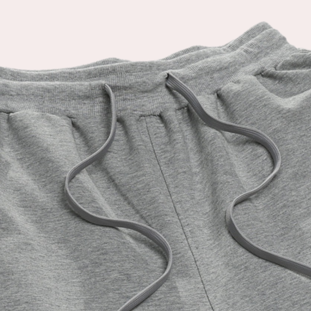 Graue Jogginghose aus Baumwolle mit Kordelzug, bequeme Sportbekleidung für Herren.