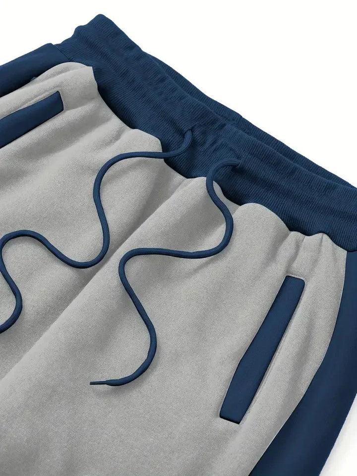 Graue Jogginghose mit blauen Streifen, Kordelzug und Taschen, Herrenmode, Freizeitkleidung.