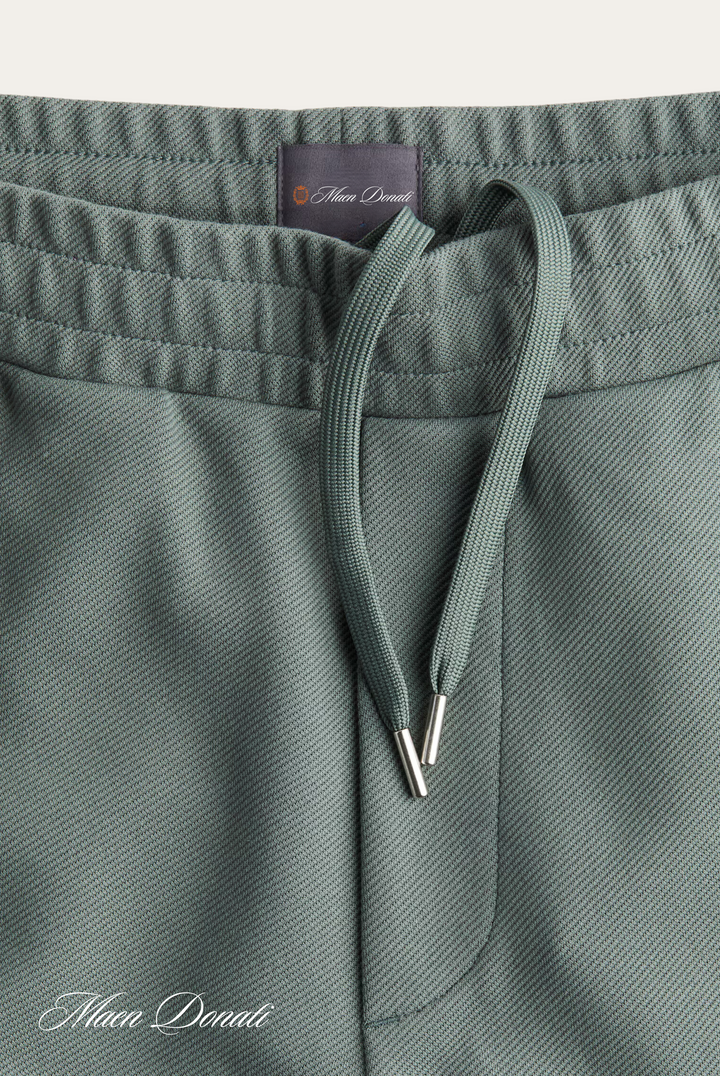 Grüne Jogginghose aus Baumwolle mit Kordelzug, bequeme Sportbekleidung für Herren.