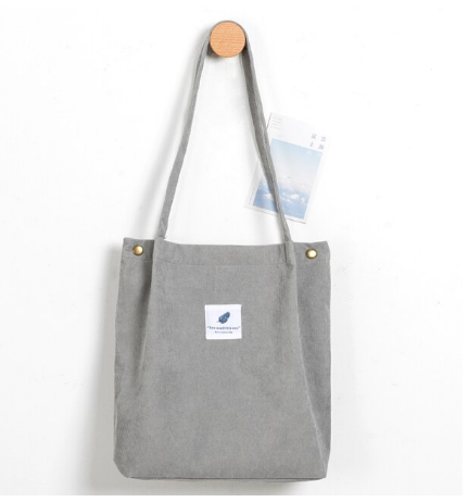 Graue Stofftasche mit langen Henkeln, minimalistisches Design, ideal für den Alltag.