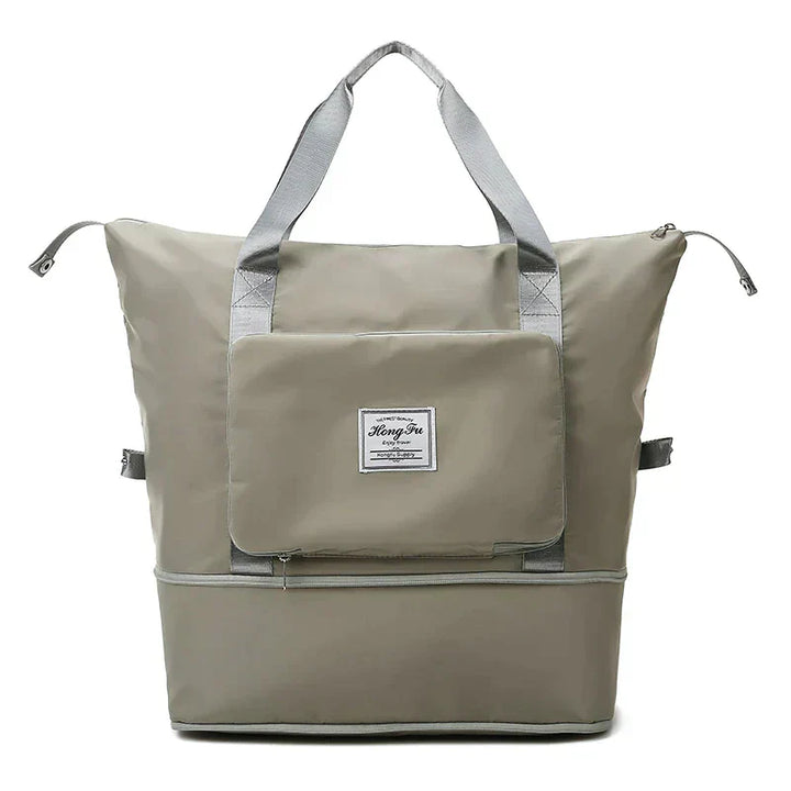 Graue Reisetasche mit Reißverschluss, großer Fronttasche, robustem Material, ideal für Reisen.