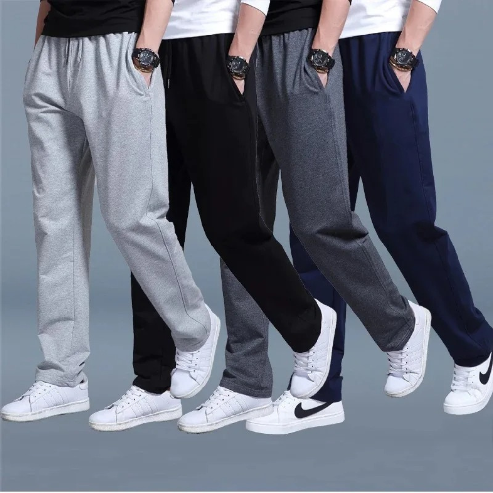 Vier Herren-Jogginghosen in Grau, Schwarz und Blau, Baumwolle, sportlich, bequem.