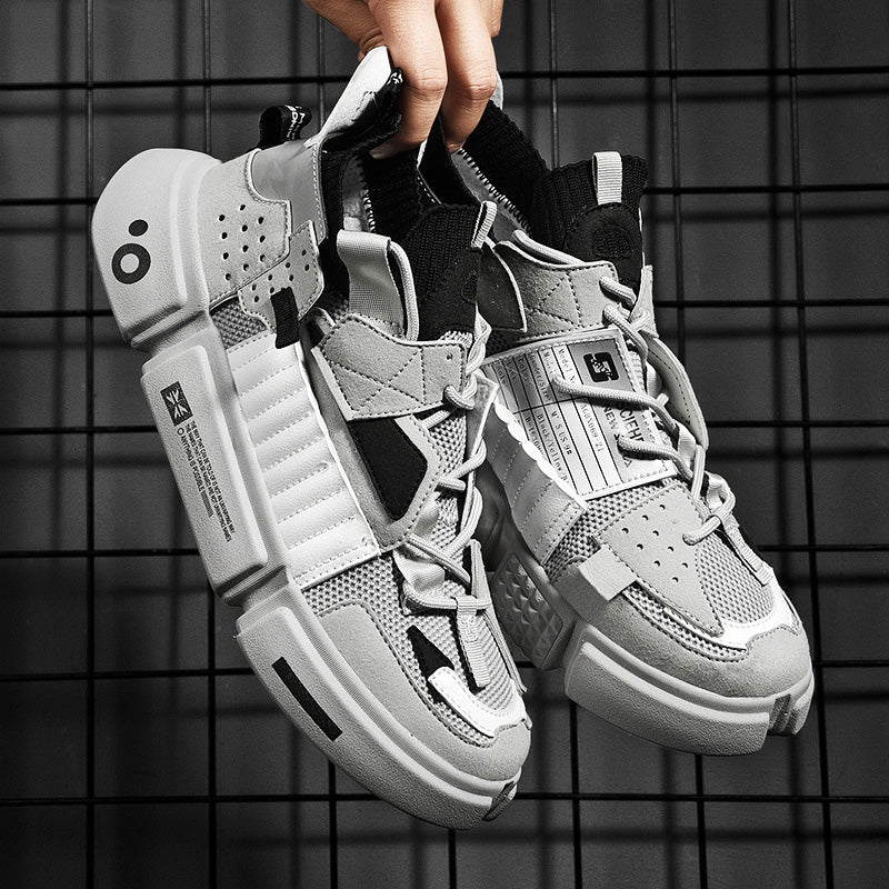 Graue Sneaker mit modernem Design, atmungsaktivem Mesh und robusten Sohlen für Herren.