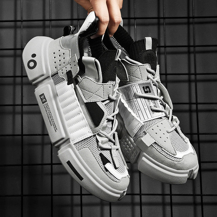 Graue Sneaker mit modernem Design, atmungsaktivem Mesh und robusten Sohlen für Herren.