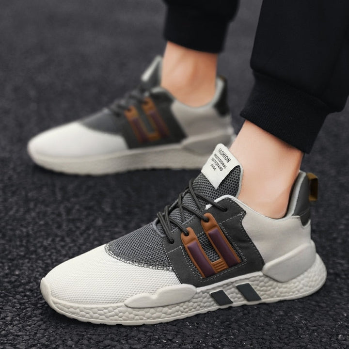 Graue Sneaker mit Mesh-Obermaterial, Gummisohle, ideal für Laufen und Freizeitmode.