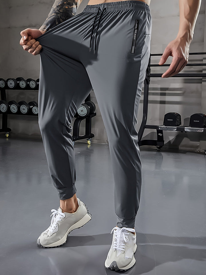 Graue Herren-Trainingshose, elastisch, atmungsaktiv, ideal für Fitnessstudio und Sport.