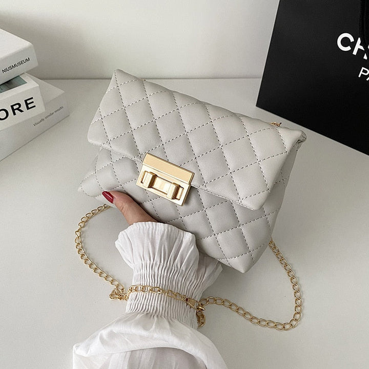 Graue gesteppte Handtasche mit goldener Kette, elegantes Design, Damenmode Accessoire.