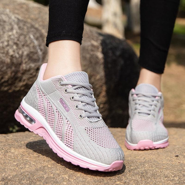 Graue und rosa Damen-Sneaker, atmungsaktiv, mit Luftpolstersohle, ideal für Laufen und Freizeit.