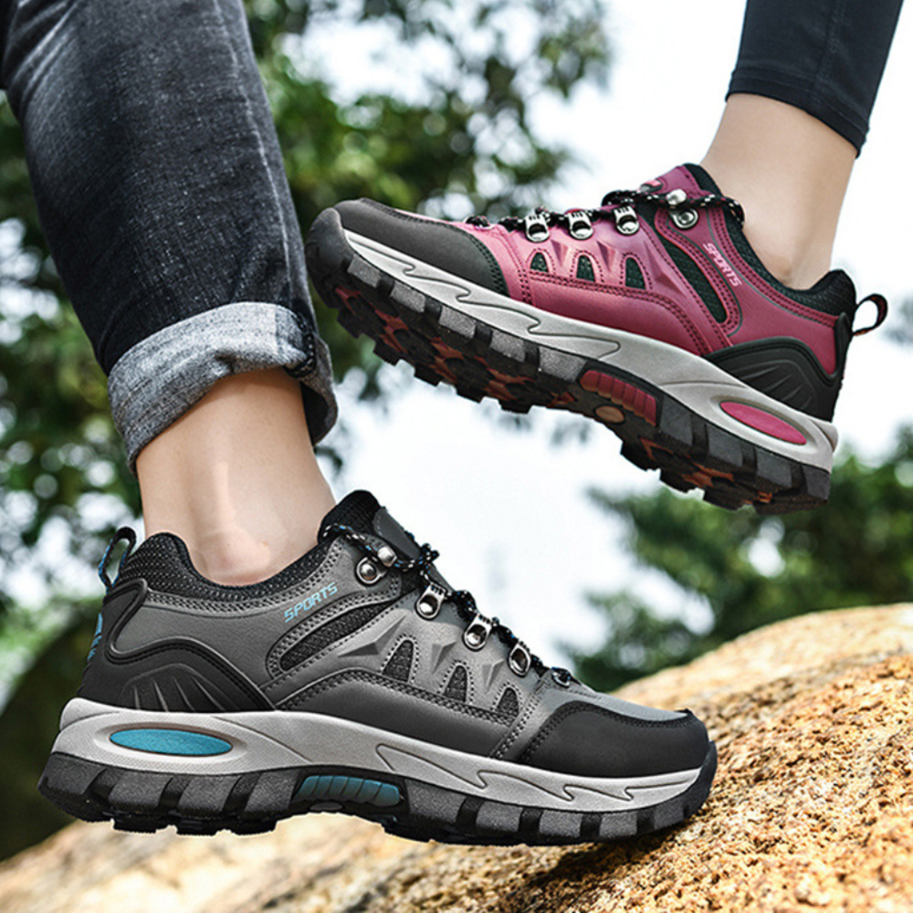 Graue und pinke Wanderschuhe, robust, rutschfest, ideal für Outdoor-Aktivitäten.