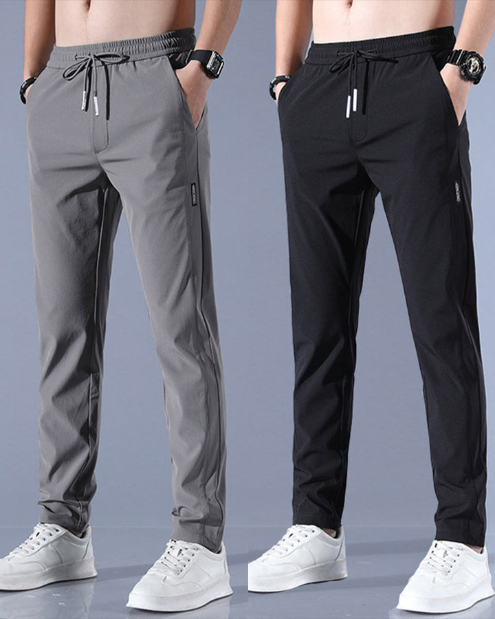 Graue und schwarze Herren-Sporthosen, elastischer Bund, Kordelzug, seitliche Taschen.