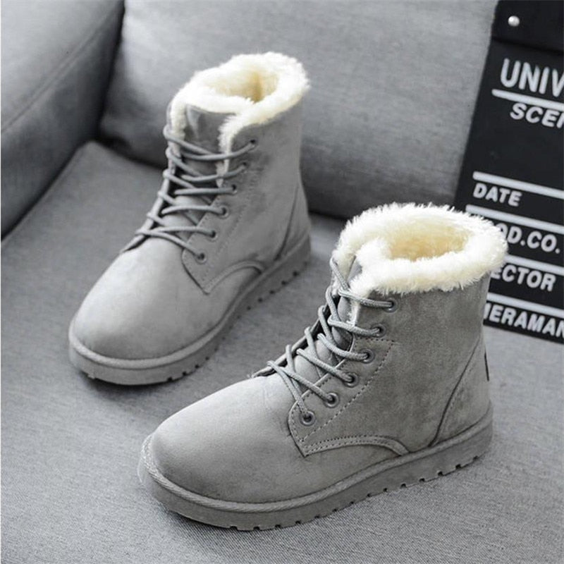Graue Winterstiefel mit Kunstfellfutter, Schnürung, rutschfeste Sohle, warm, modisch.