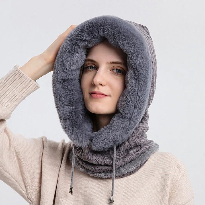 Frau mit grauem Kunstpelz-Schal, Kapuze, Wintermode, warm, stilvoll, gemütlich.