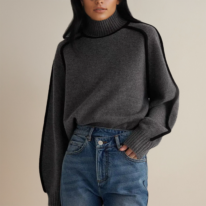 Frau in grauem Rollkragenpullover und blauer Jeans, modisch, Herbstmode, Damenbekleidung.
