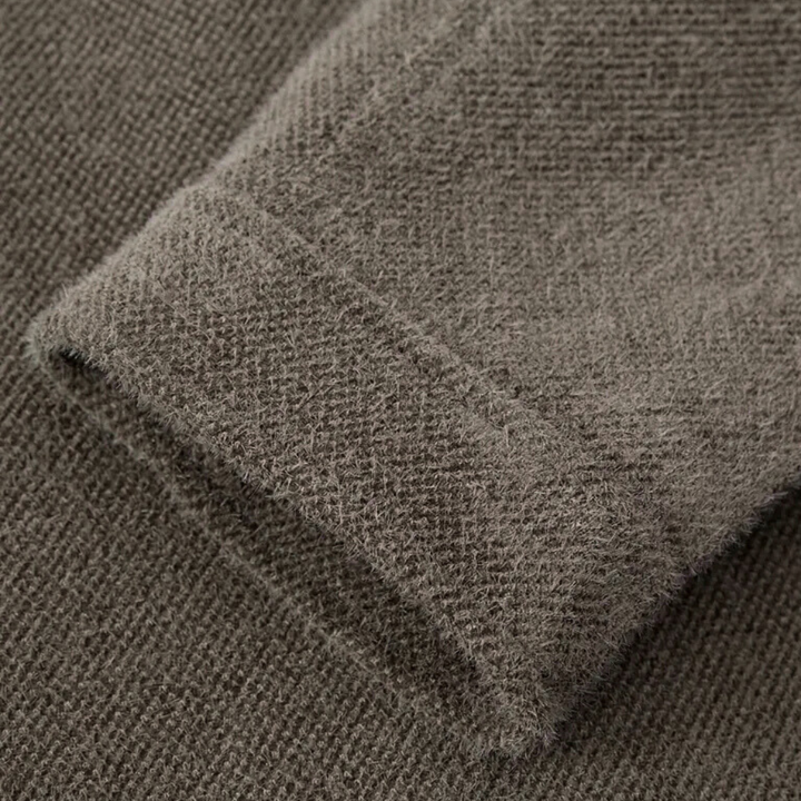 Brauner Strickpullover-Ärmel, weiches Material, Nahaufnahme, Textur, Wintermode.
