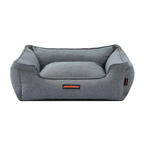 Graues Hundebett aus Stoff, rechteckig, bequem, ideal für mittelgroße Hunde.