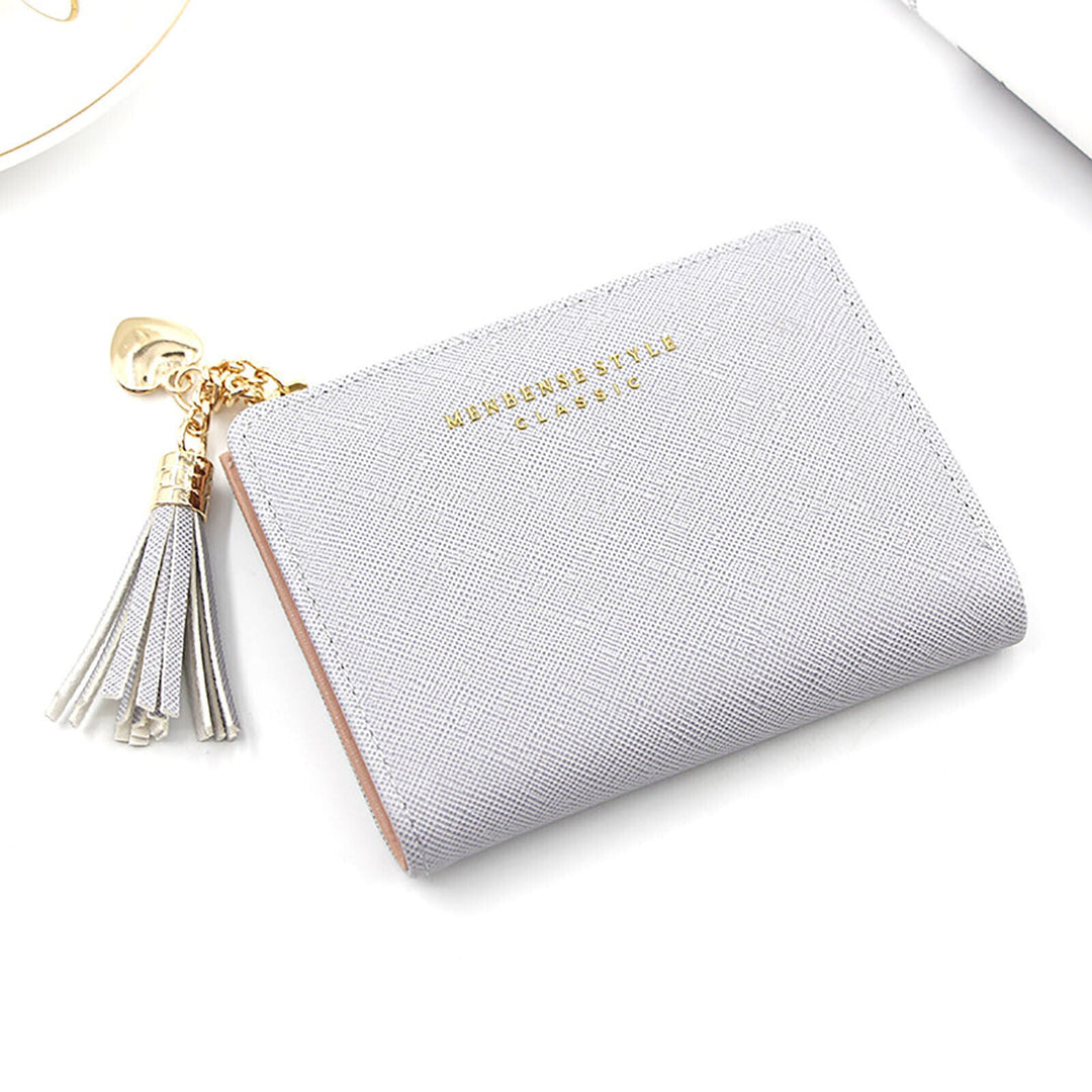 Graues Damenportemonnaie aus Leder mit Quaste und goldenen Akzenten, elegant und stilvoll.
