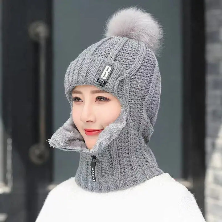Graue Strickmütze mit Bommel und Reißverschluss, warme Wintermütze für Damen.