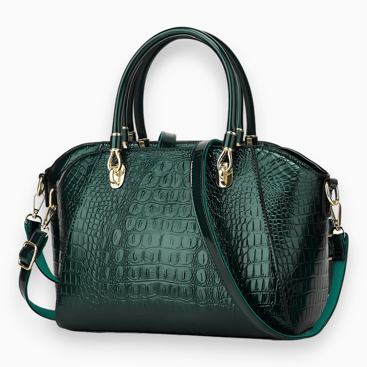 Dunkelgrüne Krokodilleder-Handtasche mit goldenen Beschlägen und abnehmbarem Schulterriemen.