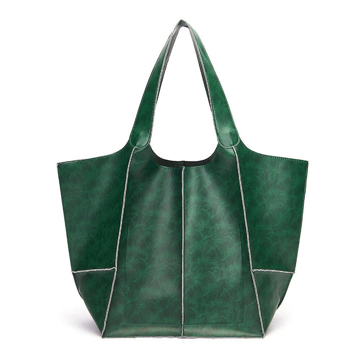 Grüne Ledertasche, große Einkaufstasche, modisches Accessoire, umweltfreundlich, Damenmode.