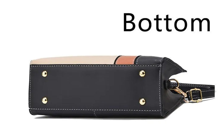 Schwarze Lederhandtasche mit goldenen Nieten, Bodenansicht, modisch, elegant, Damenaccessoire.