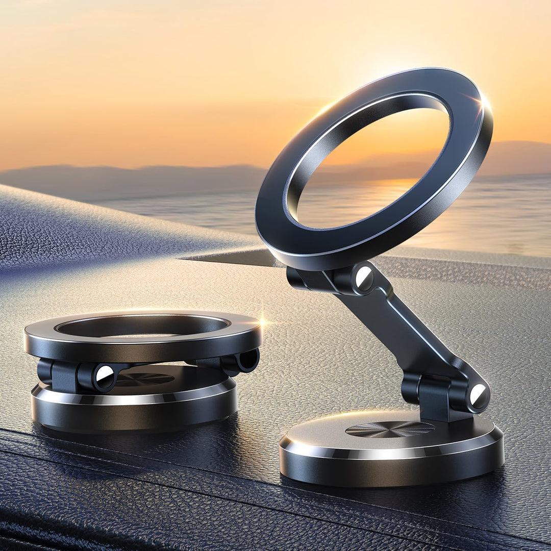 Zwei schwarze magnetische Handyhalterungen aus Metall auf Armaturenbrett im Sonnenuntergang.