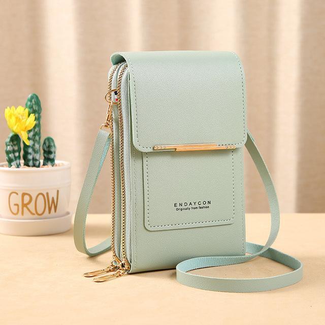 Grüne Damenhandtasche aus Leder mit Reißverschluss und Schulterriemen, modisch und elegant.