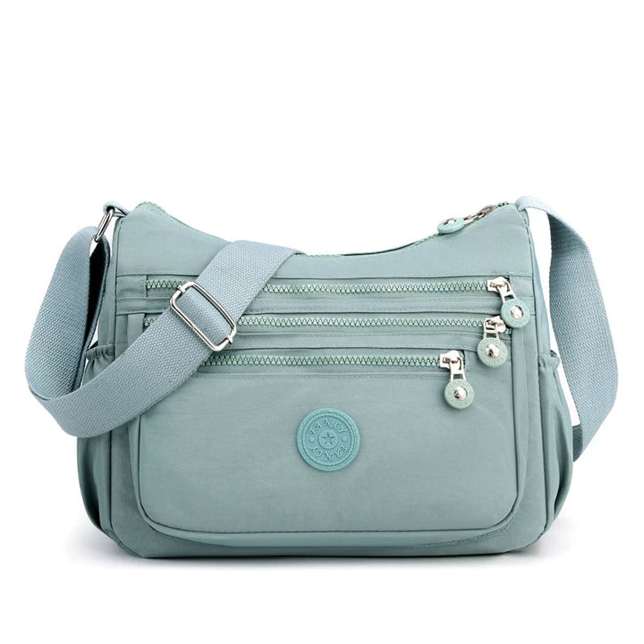 Hellblaue Umhängetasche Damen, Nylon, mehrere Reißverschlüsse, verstellbarer Schultergurt.