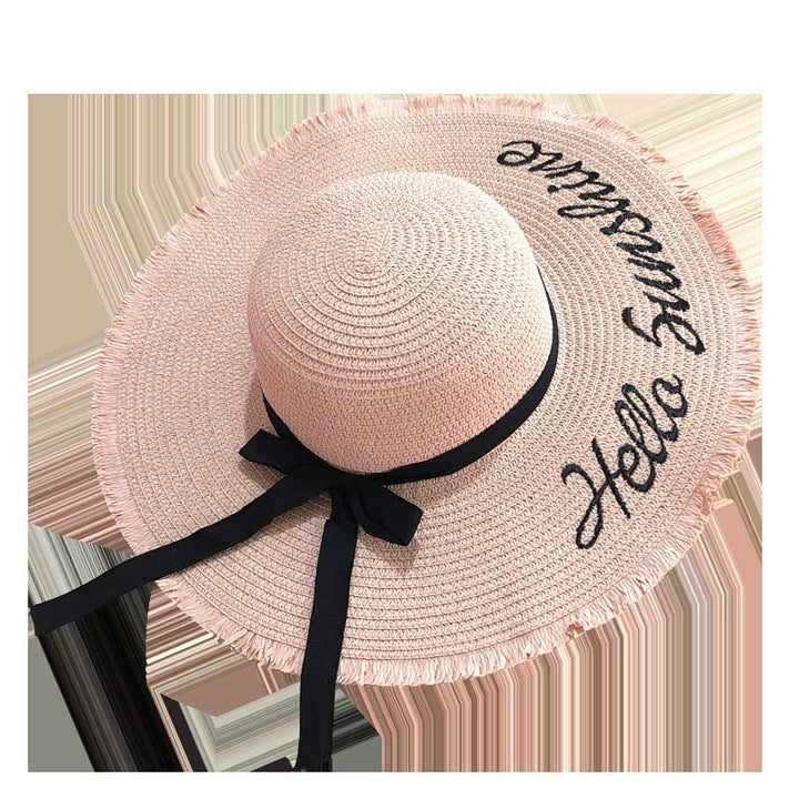 Rosa Damen-Sonnenhut mit schwarzer Schleife und Schriftzug, Sommermode Accessoire.