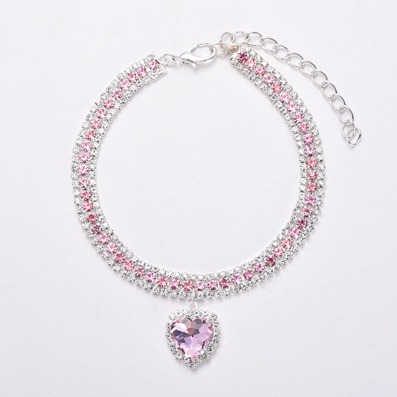 Silbernes Armband mit rosa Kristallen und herzförmigem Anhänger, eleganter Schmuck für Damen.