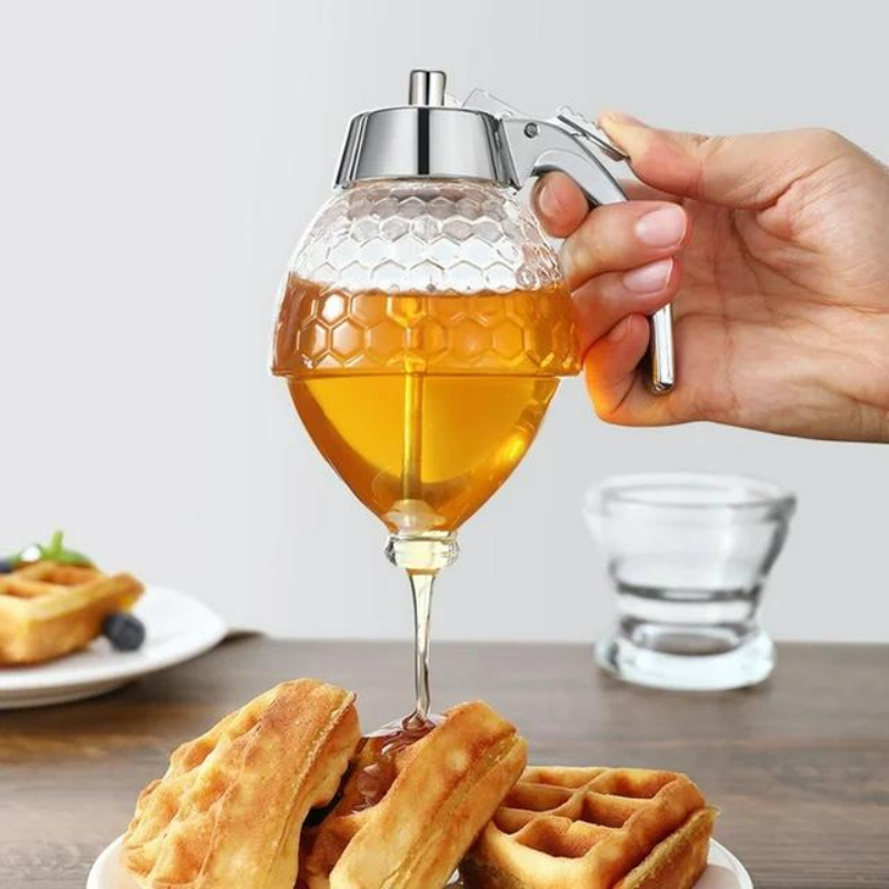 Honigspender aus Glas in Granatenform, gießt Honig auf Waffeln, ergonomischer Griff.