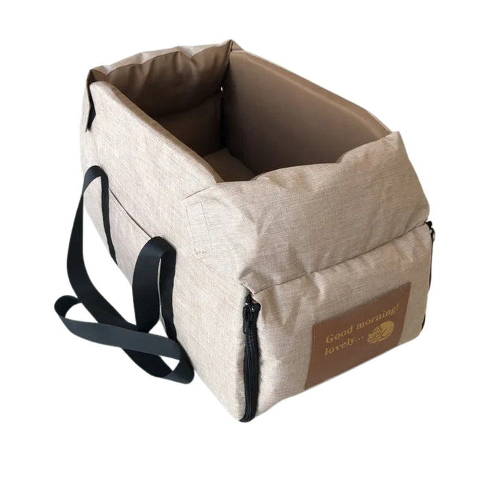 Beige Haustiertragetasche mit schwarzen Trägern, ideal für Hunde und Katzen, aus robustem Material.