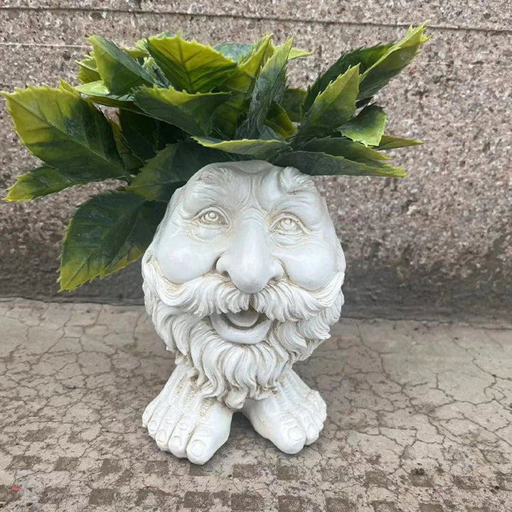 Keramik-Blumentopf in Form eines Gesichts mit grünen Blättern, dekorativer Gartenartikel.