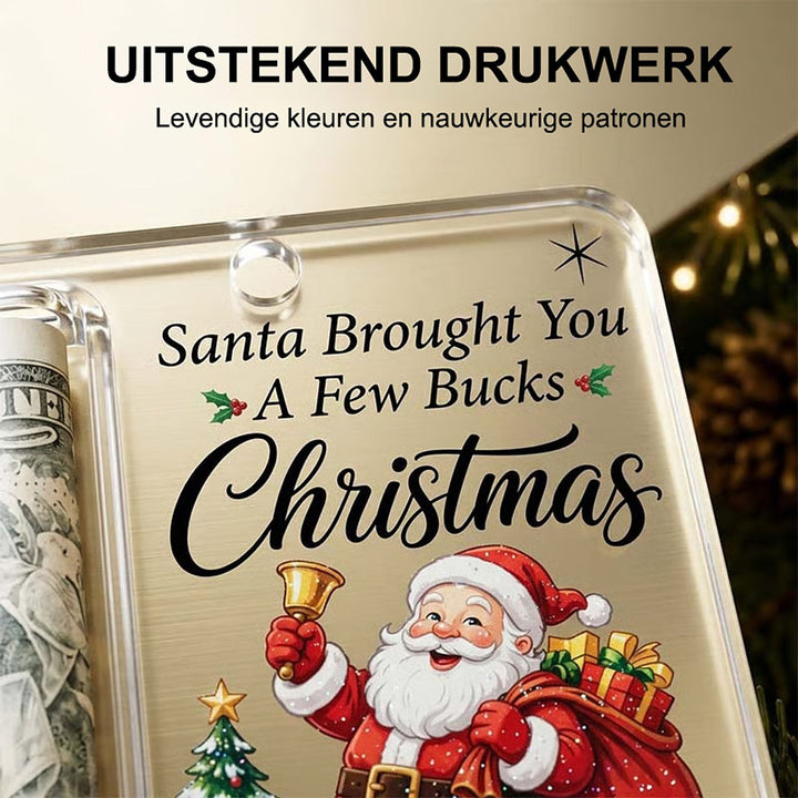 Detailní záběr rohu ozdoby s potiskem Santy se zvonkem, malým výstupkem u otvoru a srolovanou bankovkou vlevo. 4