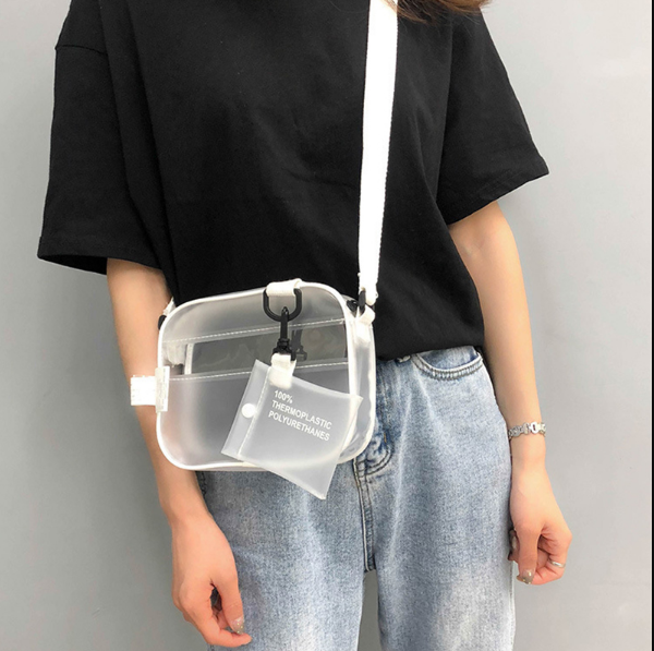 Frau mit transparenter Umhängetasche aus Kunststoff, weißer Riemen, lässiges Outfit.