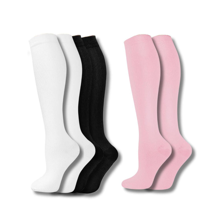 Weiße, schwarze und rosa Kompressionsstrümpfe, knielang, unisex, für Sport und Reisen.