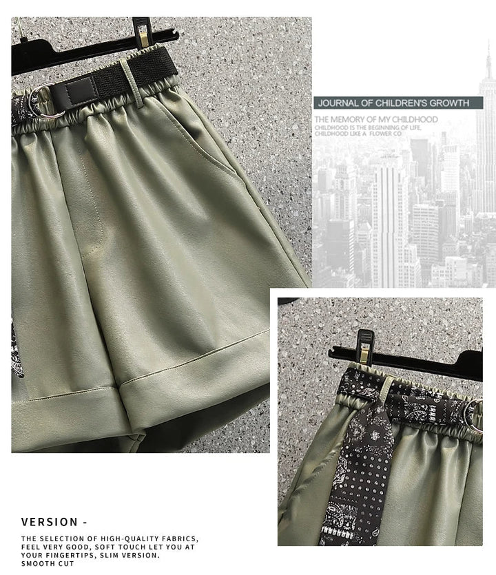 Grüne Damen-Shorts aus Satin mit schwarzem Gürtel und Muster, elegant und modisch.